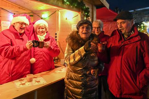Mit Glühwein wärmen sich Dagmar Heinze und Wolfgang Eckstein am Stand des Carnevalvereins Groß-Gerau, wo (von links) Elfriede Gradwohl und Birgit Richter die Gäste versorgen. © Samantha Pflug
