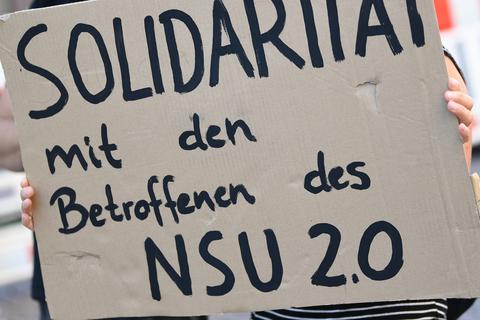 Ein Demonstrantin hält während einer Kundgebung in der Wiesbadener Innenstadt ein Plakat. Foto: dpa