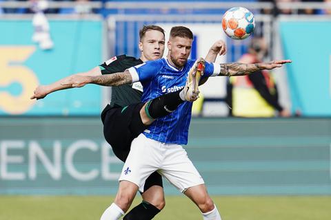 Bremens Niklas Schmidt (l) uns Darmstadts Tobias Kempe kämpfen um den Ball. Foto: dpa/Uwe Anspach 
